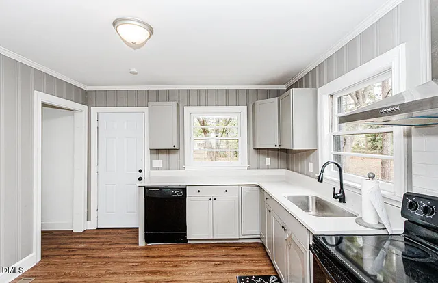 a kitchen with stainless steel appliances granite countertop a sink stove and cabinets