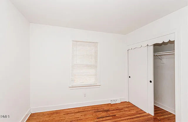 a view of a room with wooden floor and closet