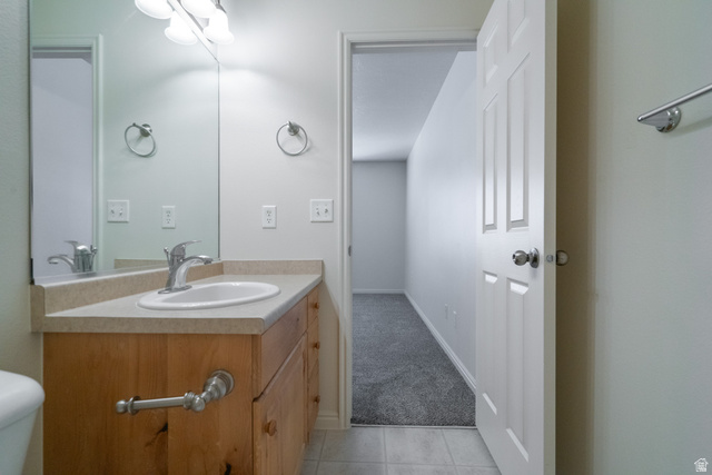 1735 West 540 North, Unit 1805 St. George, UT 84770 - Photo 51 of 64 Bathroom vanity featuring a light-toned countertop, integrated sink, and wood-panel cabinetry