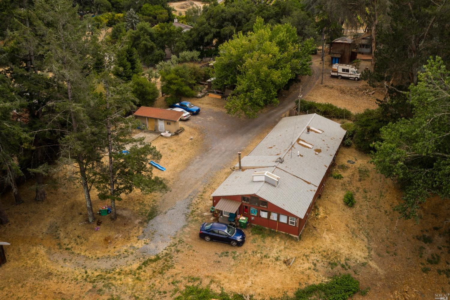 an aerial view of a house with a yard basket ball court and outdoor seating