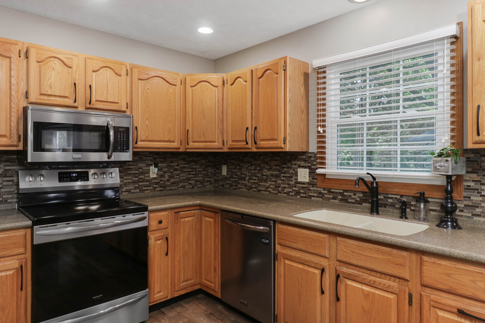 3203 Eagle Crest Road Bloomington, IL 61704 - Photo 10 of 52 a kitchen with stainless steel appliances granite countertop white cabinets granite counter tops and a window