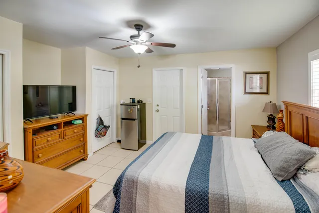 a bedroom with a bed and a flat screen tv
