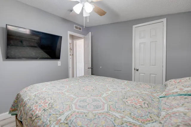 a bedroom with a bed and a flat screen tv