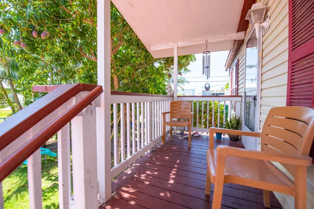 a view of balcony with wooden floor and outdoor seating