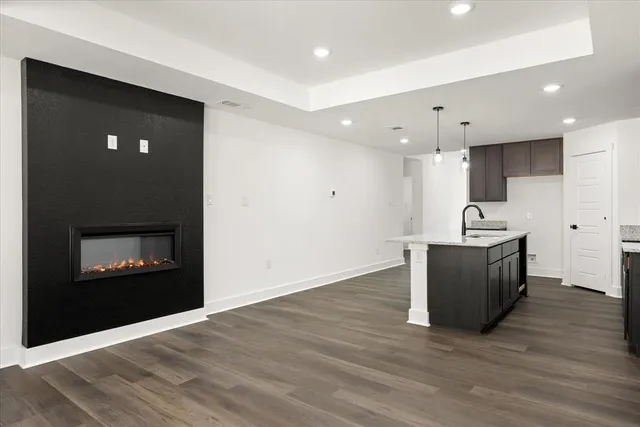 a living room with a fireplace furniture and a wooden floor