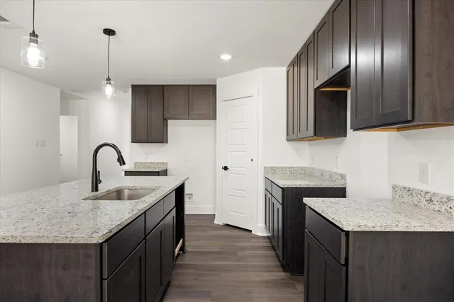 a kitchen with granite countertop stainless steel appliances and wooden cabinets