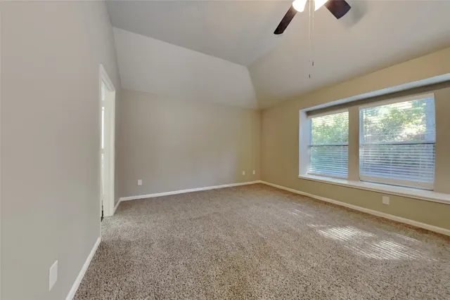 an empty room with a empty space and windows