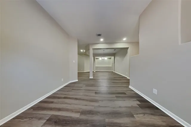 a view of a room with wooden floor and white walls
