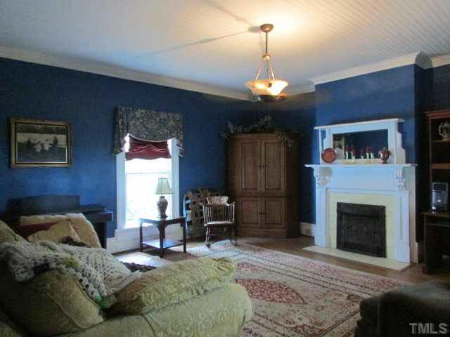 5111 Semora Road Roxboro, NC 27574 - Photo 8 of 25 a living room with furniture and a fireplace