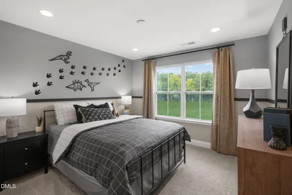 a spacious bedroom with a bed and a window