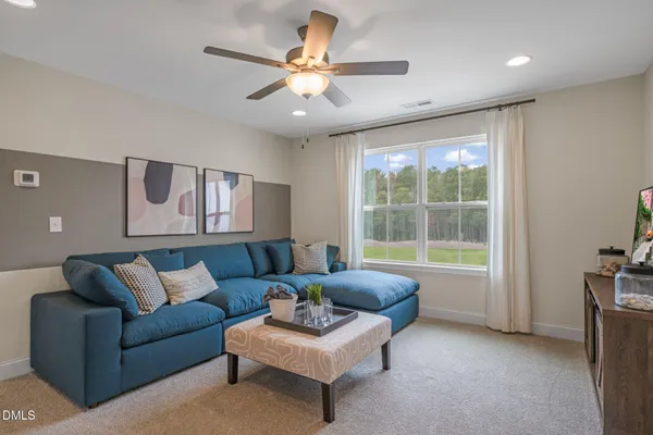 a living room with furniture and a large window