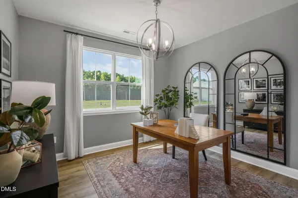 a workspace with wooden floor and a potted plant