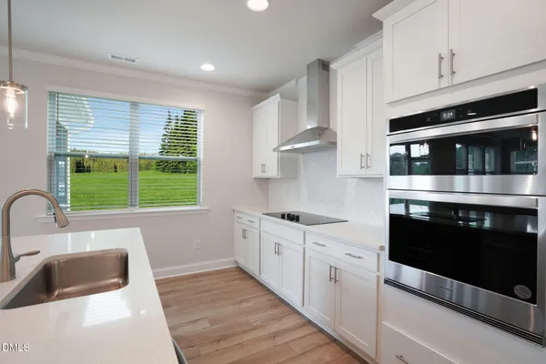 a kitchen with stainless steel appliances a sink stove and cabinets