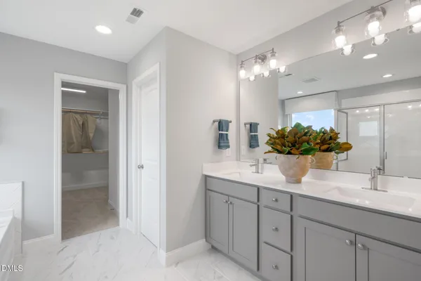 a bathroom with a sink vanity and a mirror