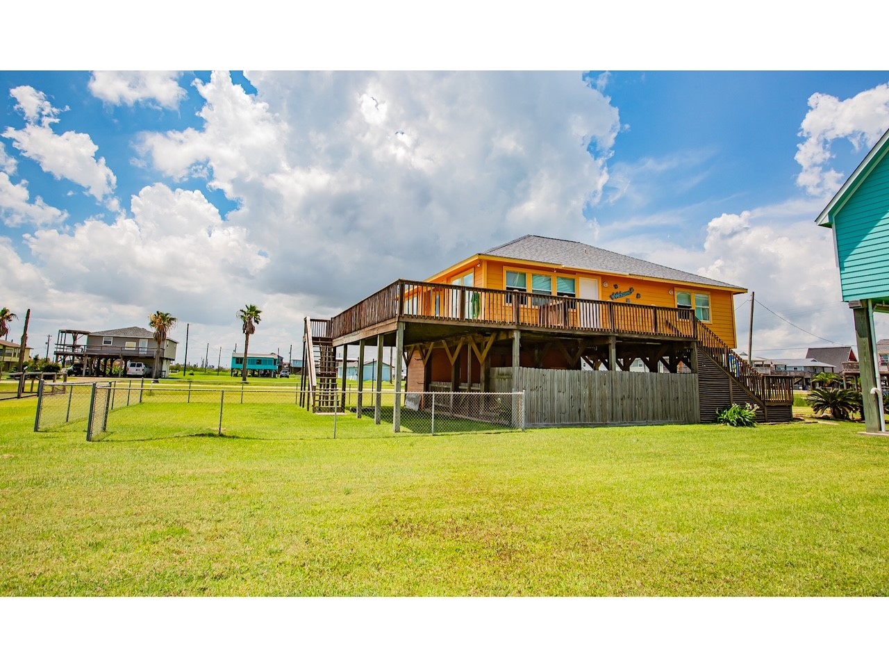 419 Thunder Road Surfside Beach, TX 77541 - Photo 1 of 32 Convenient back stairs lead directly to the spacious backyard.