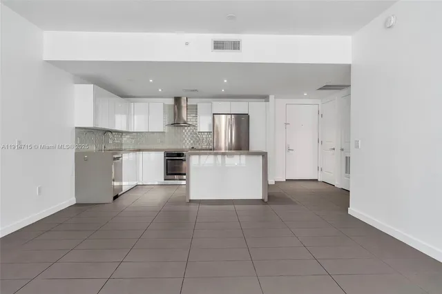 a view of kitchen with white cabinets