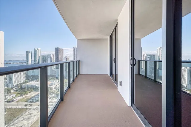 a view of a hallway with wooden floor and a balcony