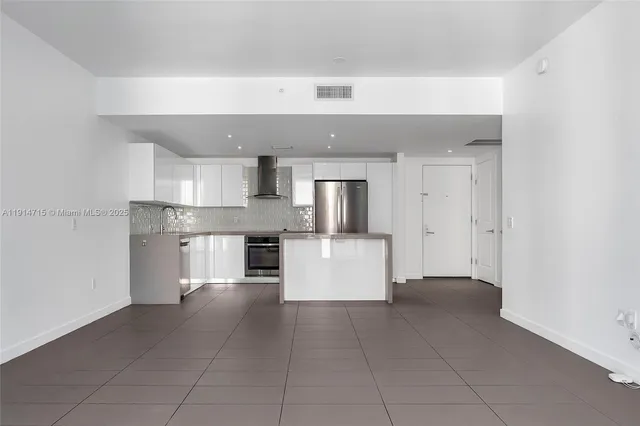 a large kitchen with cabinets and stainless steel appliances