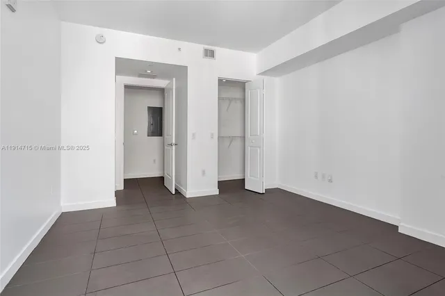 a view of an empty room with closet area