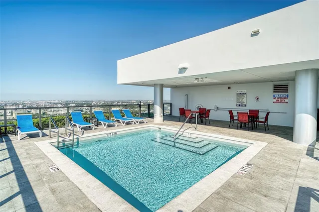 a swimming pool view with a outdoor seating space