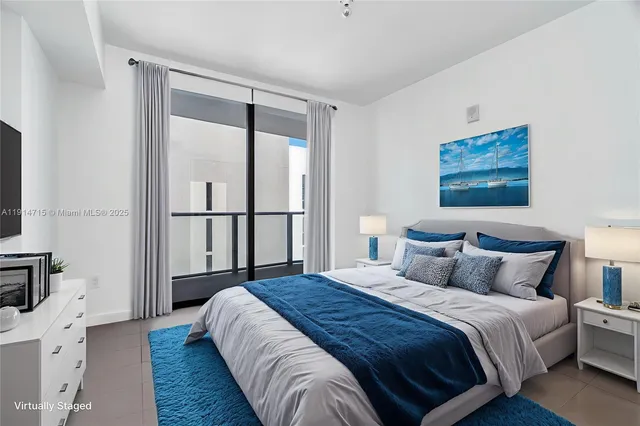 a bedroom with a large bed and a window