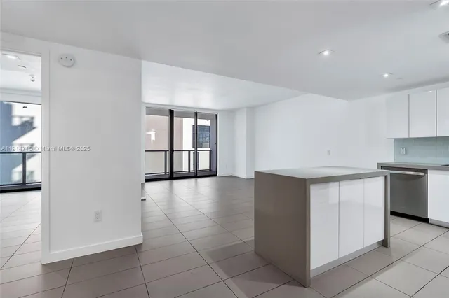 a view of a kitchen with a sink and dishwasher