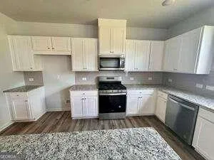 a kitchen with a refrigerator stove and sink