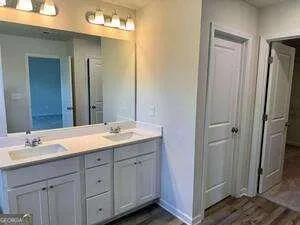 a bathroom with a granite countertop sink and a mirror