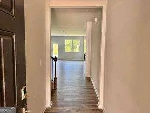 a view of a hallway with wooden floor