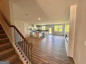 a view of entryway and hall with wooden floor