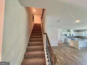a view of a kitchen with wooden floor and electronic appliances