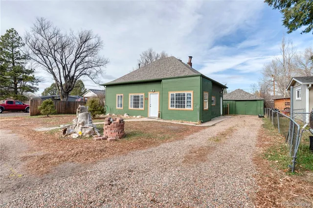 a view of a house with a yard and sitting area