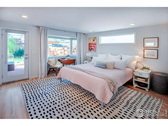 a bedroom with a bed and a painting on the wall