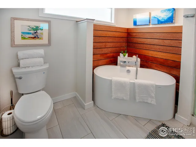 a bedroom with a bed and a mirror