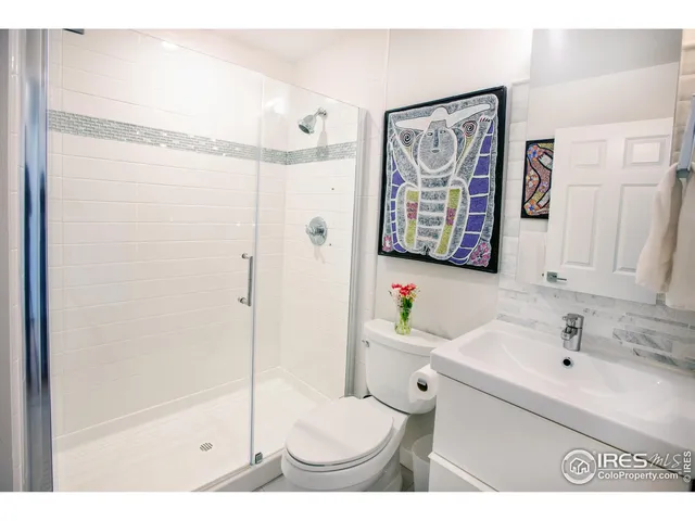 a view of a balcony with chairs and wooden floor