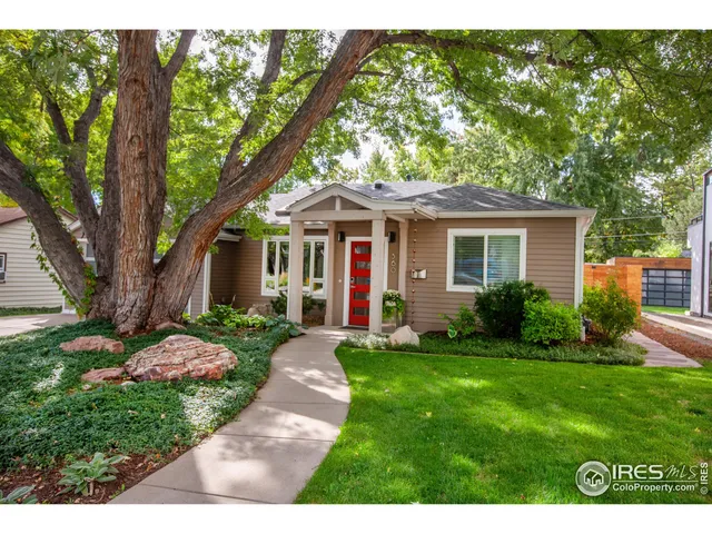 a kitchen with stainless steel appliances granite countertop a table chairs and a refrigerator