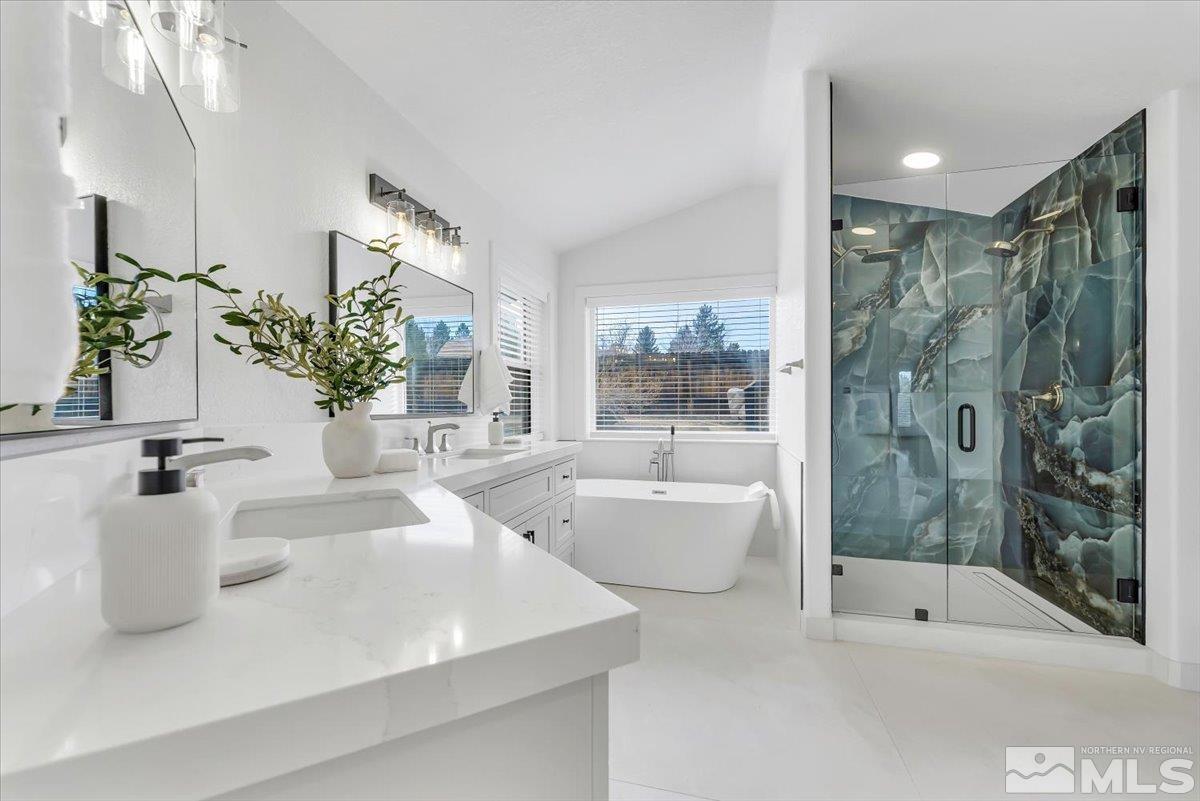 45 Water Lily Court Reno, NV 89511 - Photo 16 of 25 a bathroom with a tub sink and mirror