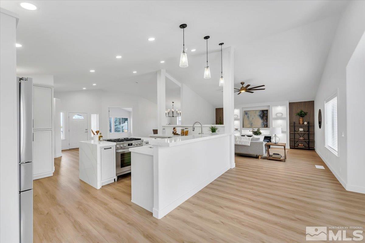 45 Water Lily Court Reno, NV 89511 - Photo 3 of 25 a large white kitchen with a large counter top appliances and cabinets