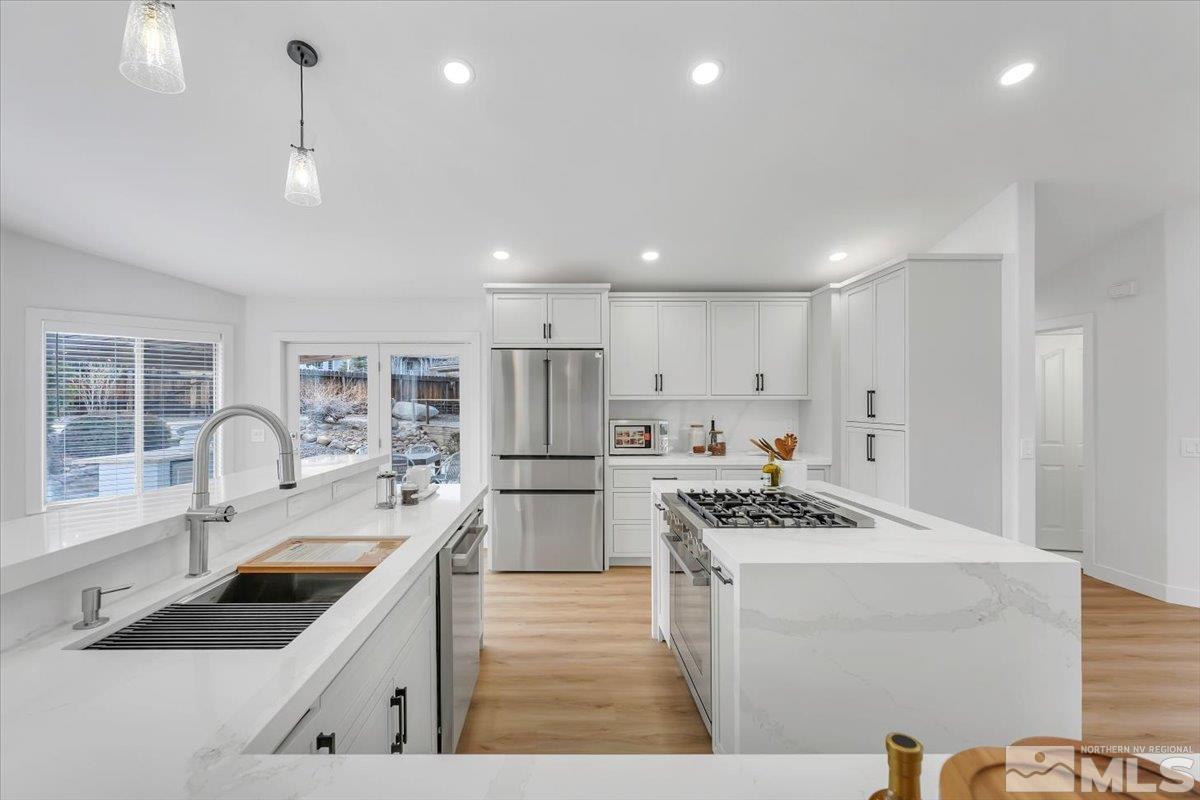 45 Water Lily Court Reno, NV 89511 - Photo 6 of 25 a kitchen that has a lot of cabinets a sink and appliances in it