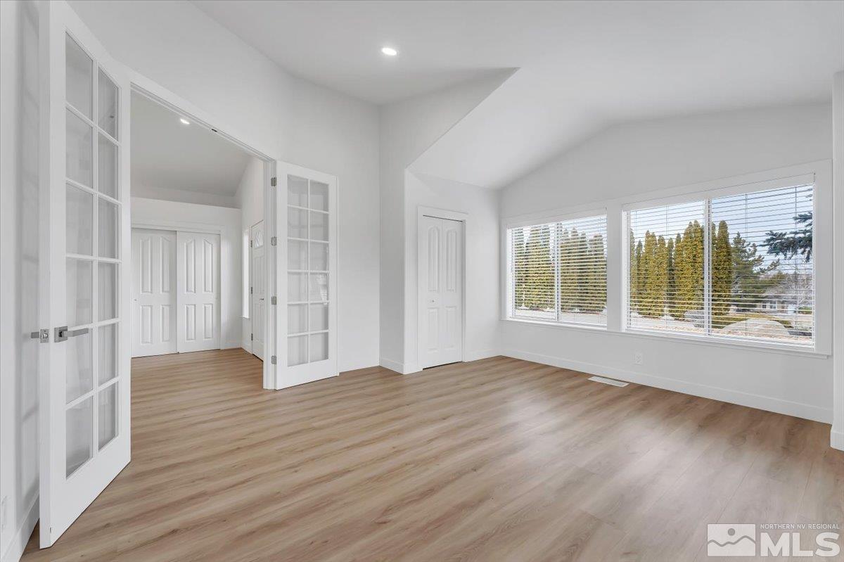 45 Water Lily Court Reno, NV 89511 - Photo 7 of 25 a view of an empty room with wooden floor and a window