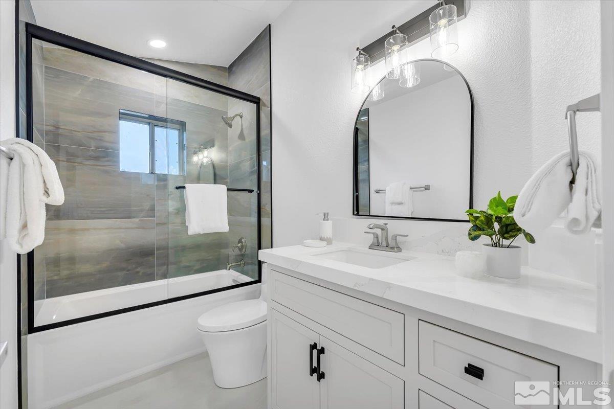 45 Water Lily Court Reno, NV 89511 - Photo 8 of 25 a bathroom with a granite countertop sink a toilet and a mirror