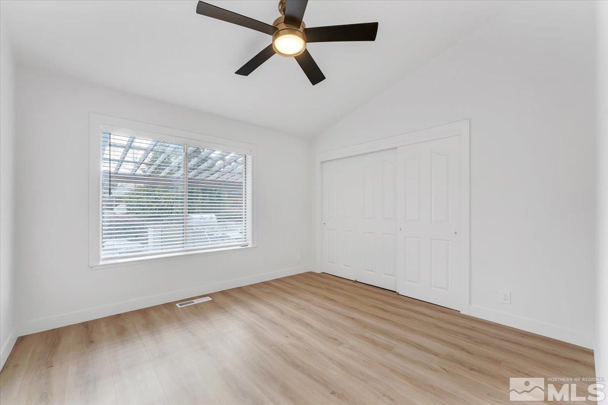 45 Water Lily Court Reno, NV 89511 - Photo 9 of 25 a view of an empty room with wooden floor and a window