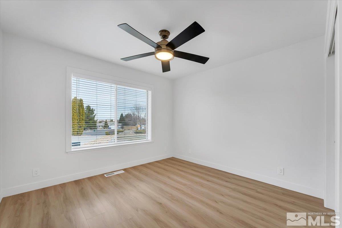 45 Water Lily Court Reno, NV 89511 - Photo 10 of 25 a view of an empty room with window and a ceiling fan