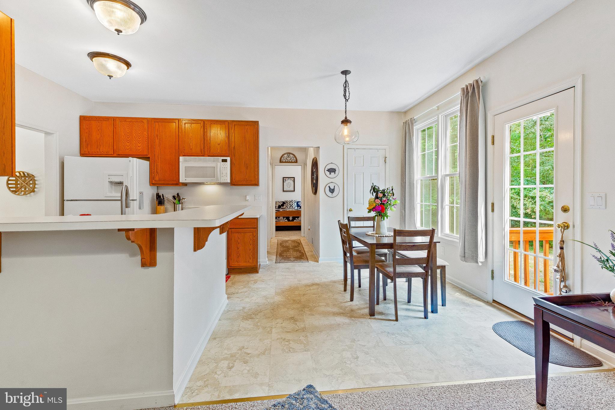 5270 Mackall Road St. Leonard, MD 20685 - Photo 15 of 42 a dining table chairs and a counter top space