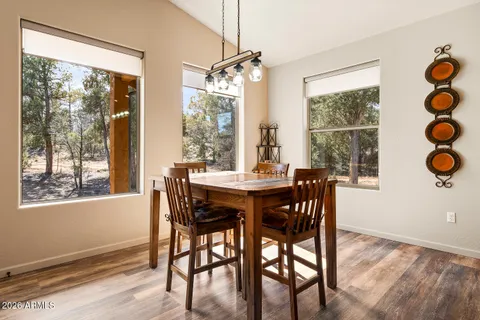 a view of a dining room with furniture wooden floor and chandelier