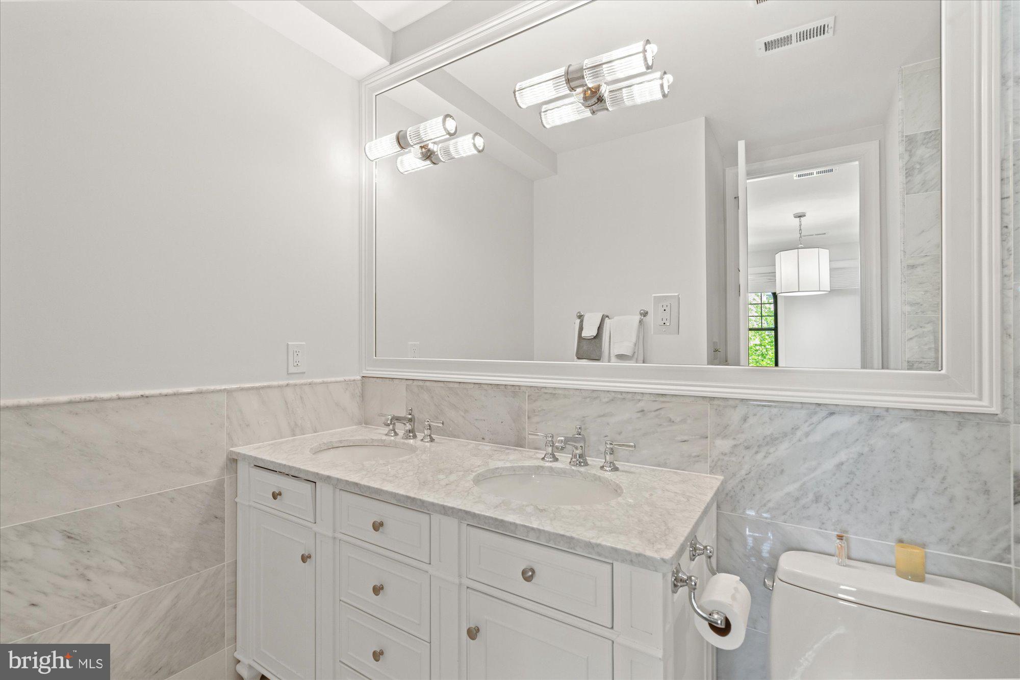 2610 Garfield Street Northwest Washington, DC 20008 - Photo 23 of 51 a bathroom with a sink vanity and a mirror