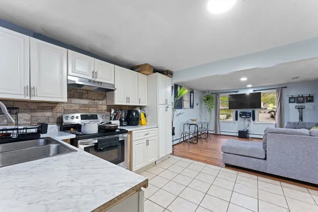 a kitchen with stainless steel appliances granite countertop a stove a sink a microwave and a refrigerator