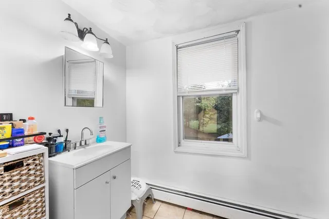 a bathroom with a sink a vanity and a window