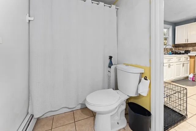 a white toilet sitting next to a bathroom sink