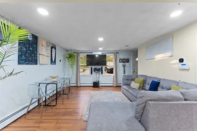 a living room with furniture and a wooden floor